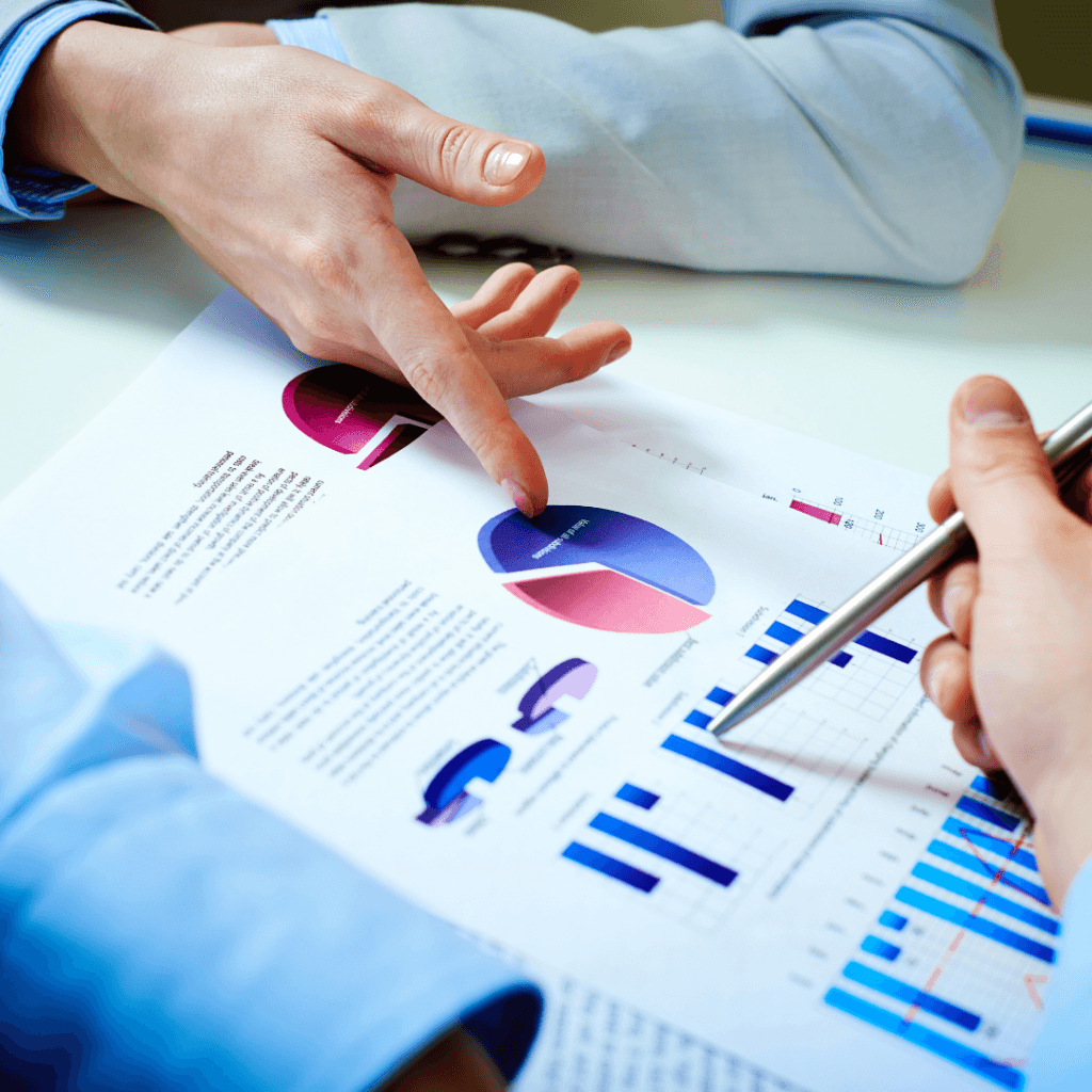 business people pointing to a chart
